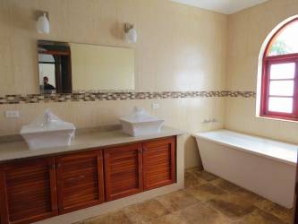 Laundry with washer, dryer, utility sink, tile floor and window in mountain villa