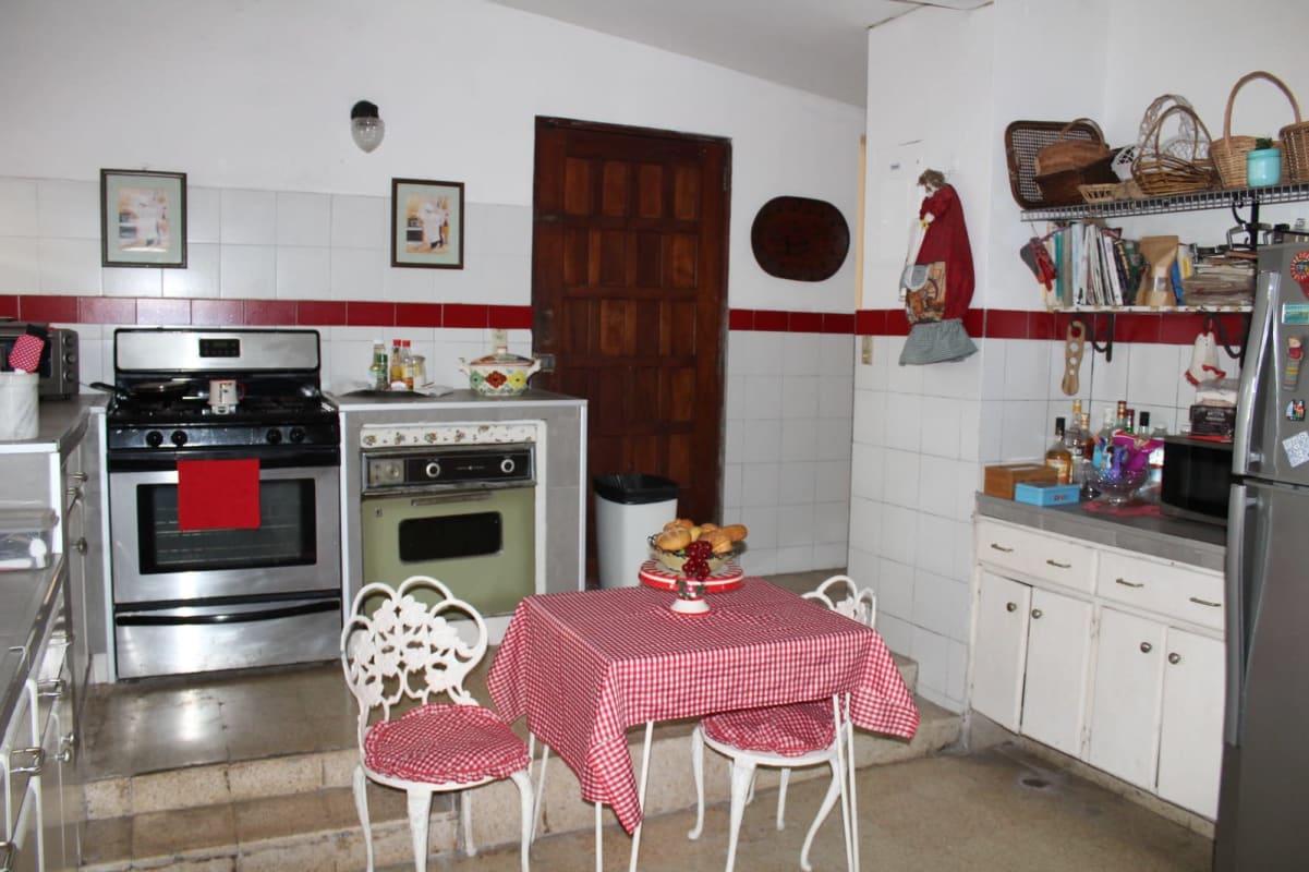 Traditional bedroom with floral bedding, wood headboard and artwork Las Cumbres Panama