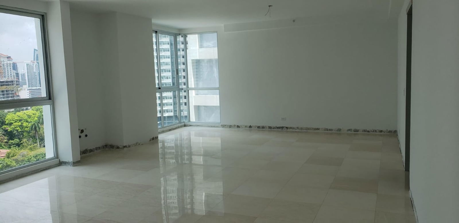 Empty luxury apartment living room with panoramic floor-to-ceiling windows in Bella Vista SkyTower Panama