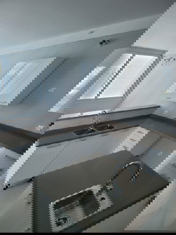 Modern luxury kitchen with island sink, window, white cabinetry PH Bella Vista SkyTower Panama