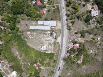 Large open yard with warehouse structures surrounded by nature in Penonomé Coclé Panama