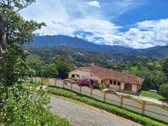 Lush green forest landscape with mountain range and expansive blue sky Boquete Panama land for sale