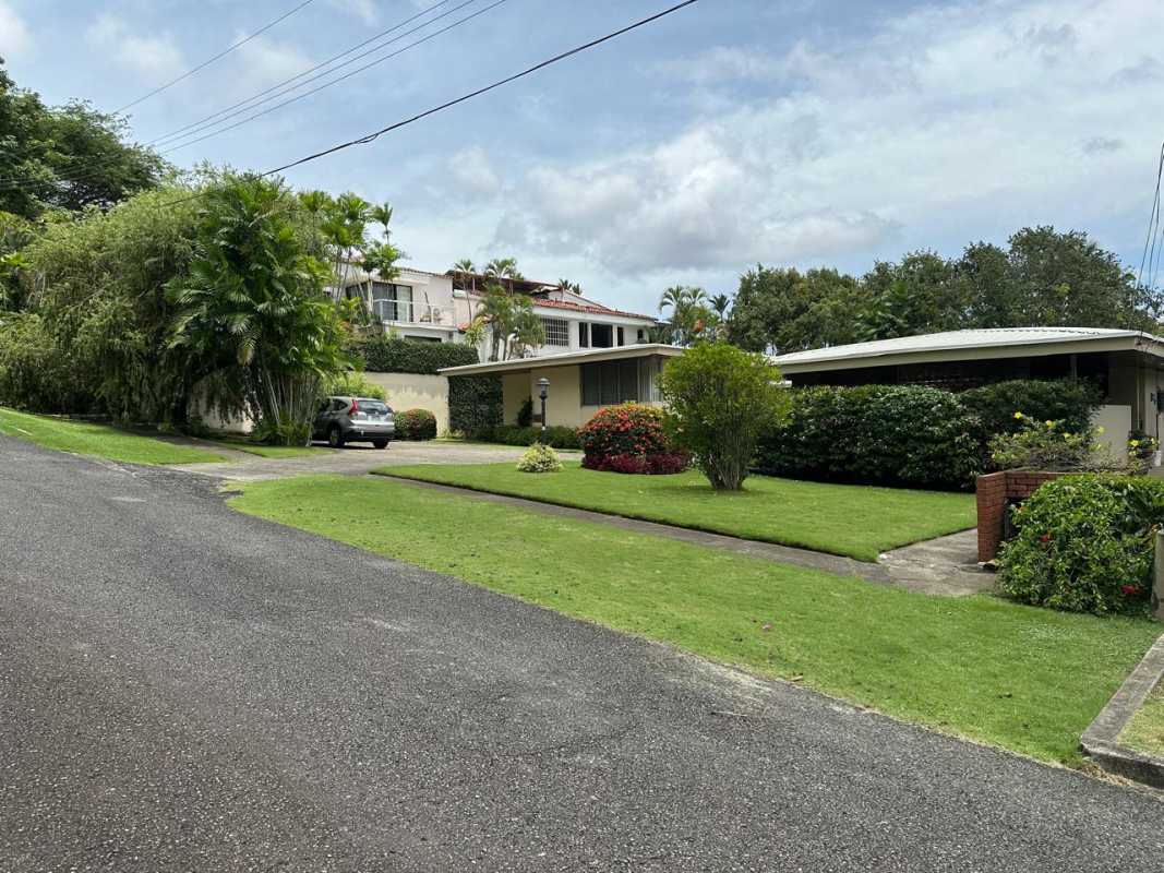 Traditional living room with wooden ceiling, large windows, entertainment center in Altos del Golf Panama