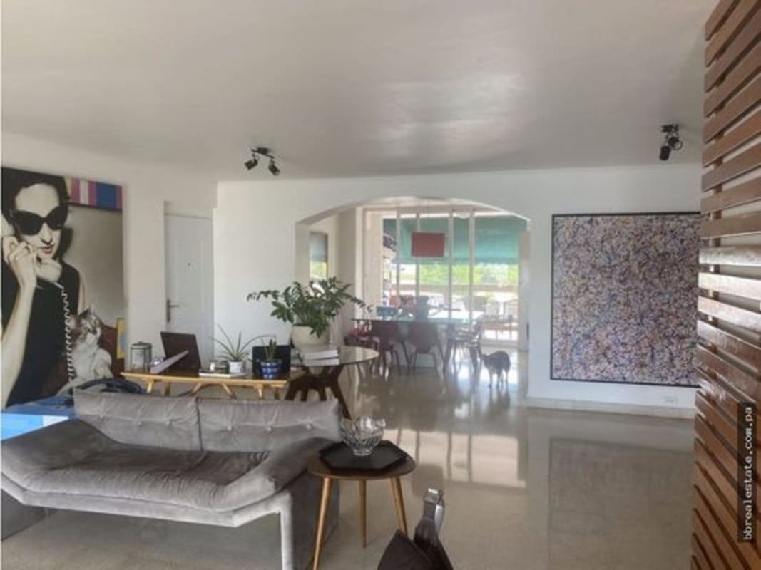 Modern open living with dining area, large wall art, and elegant furnishings at PH Las Llamas Panama