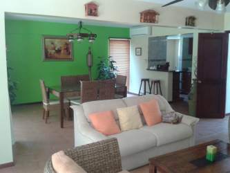 Bright interior with green accent wall at beachfront villa Playa Blanca Panama