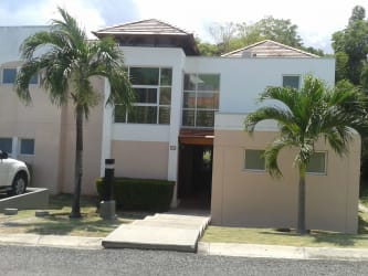 Modern two-story beach villa with tropical garden at Playa Blanca Resort