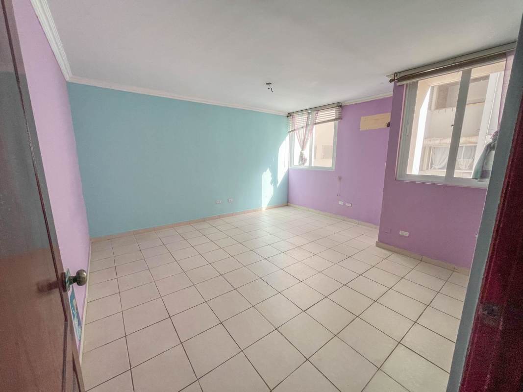 Bedroom featuring large windows, colorful walls and tiled floors in PH Brisas del Carmen Panama