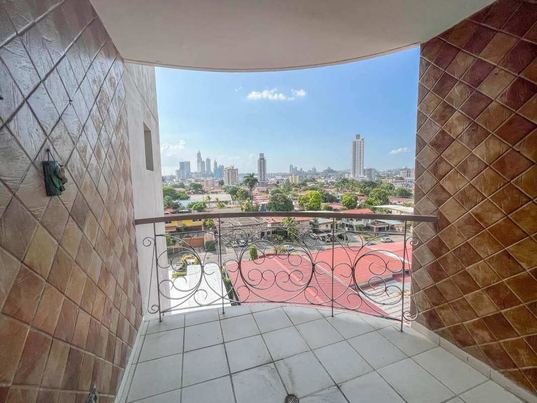 Kitchen with island cabinet, wood cabinetry and tile backsplash inside PH Brisas del Carmen Panama