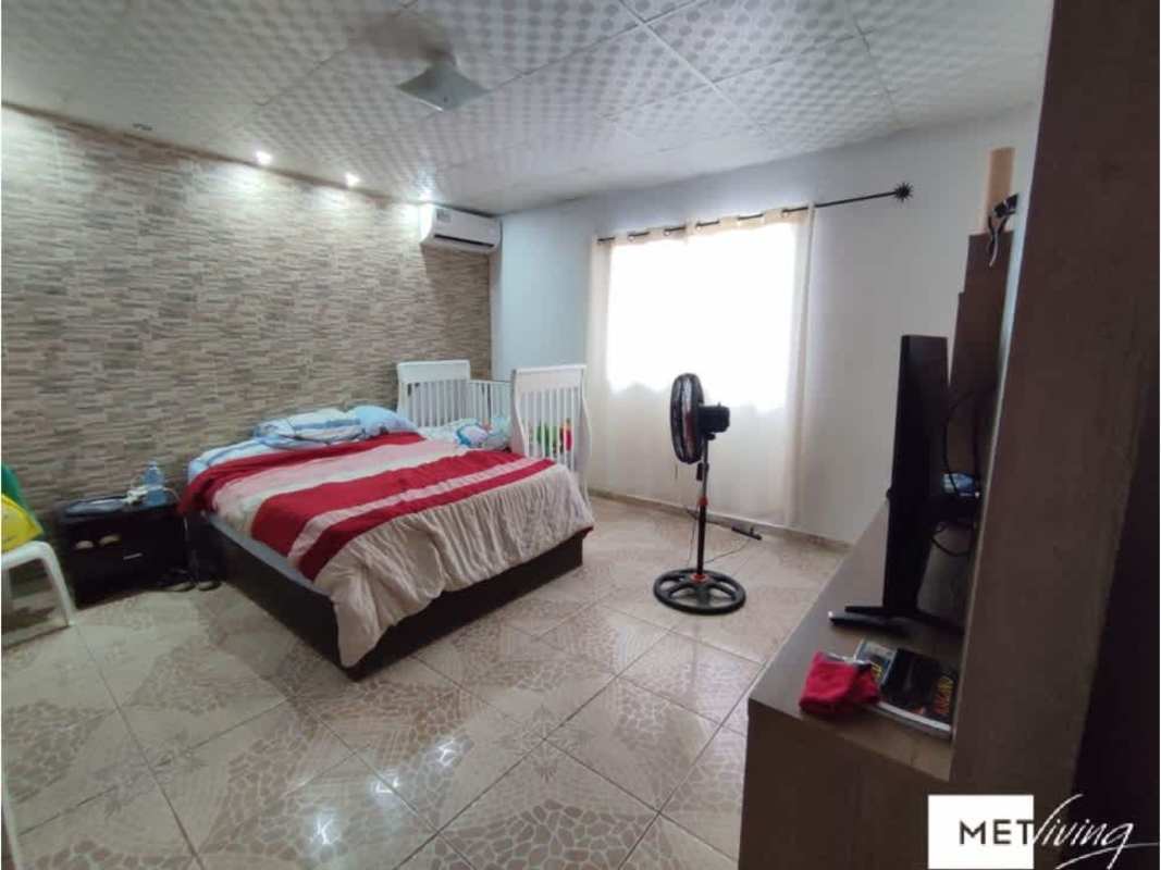 Bedroom with accent wall, beds, and tiled flooring in countryside home Utive Pacora Panama