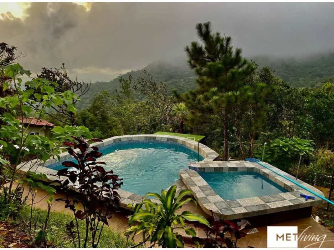 Bedroom with bunk bed, single bed, window, fan and tile floor in mountain cabin