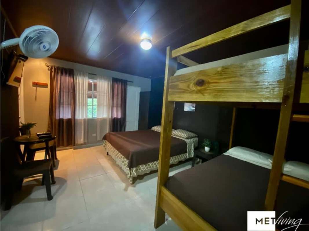 Outdoor pool and jacuzzi with panoramic views of green hills in Cerro Azul