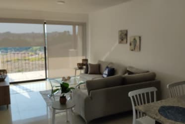 Expansive landscape view of coastline and lush fields from PH Marina Golf Condo San Carlos Panama