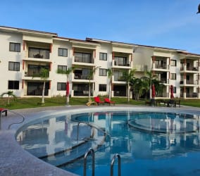 Luxury apartment building with swimming pool and landscaped gardens in Vista Mar Golf Resort Panama