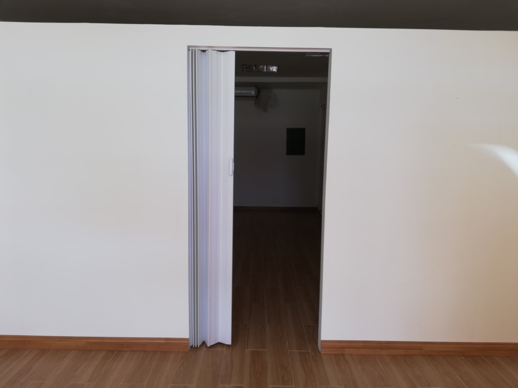 Minimalist interior hallway with folding door and wood tile floor Albrook Panama