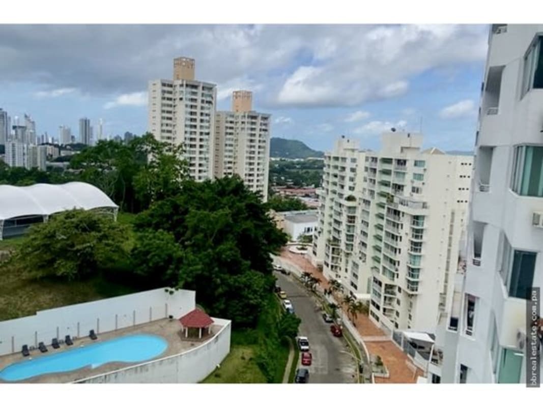 Bright master bedroom with sliding glass doors opening to balcony city mountain views in PH El Mare Edison Park Panama