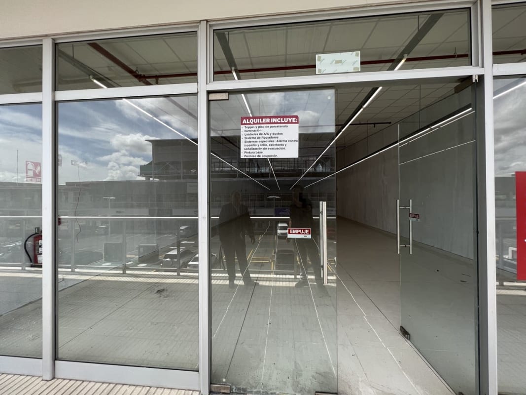 Glass storefront façade with clear signage location Metro Park Plaza Costa Sur Panama