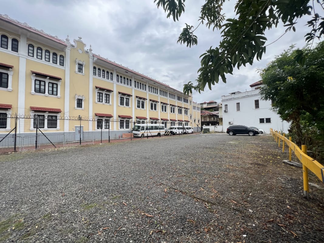 Large parking lot next to colonial yellow building near waterfront in Casco Viejo Panama