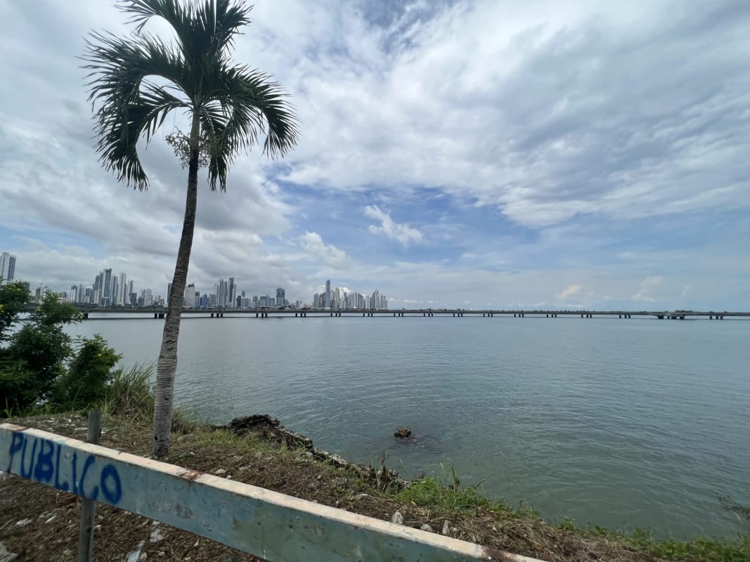 Colonial style waterfront building on pilings with ocean and skyline view Casco Viejo Panama