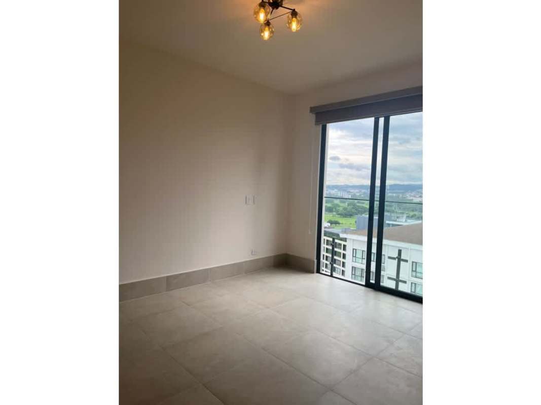 Living room with sliding doors to balcony overlooking golf course at Ocean House Santa María Panama