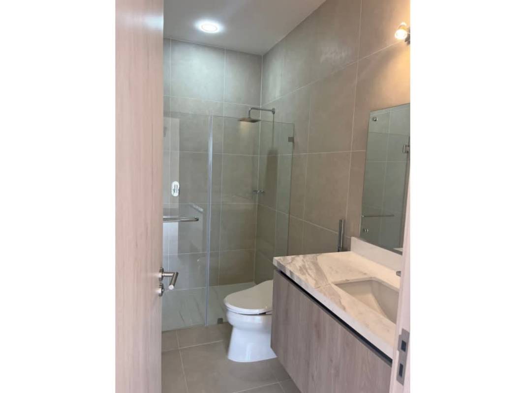 Modern bathroom with marble vanity and glass enclosed shower in Ocean House Santa María