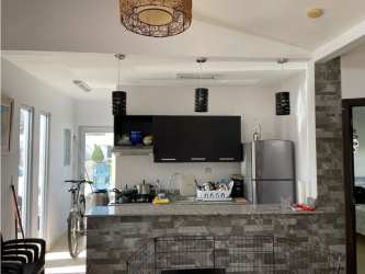 Kitchen with stone tile breakfast bar, fridge, pendant lights Ibiza Beach Residences Río Hato