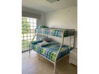 Bedroom with bunk bed, large glass sliding door and garden view Ibiza Beach Residences Panama