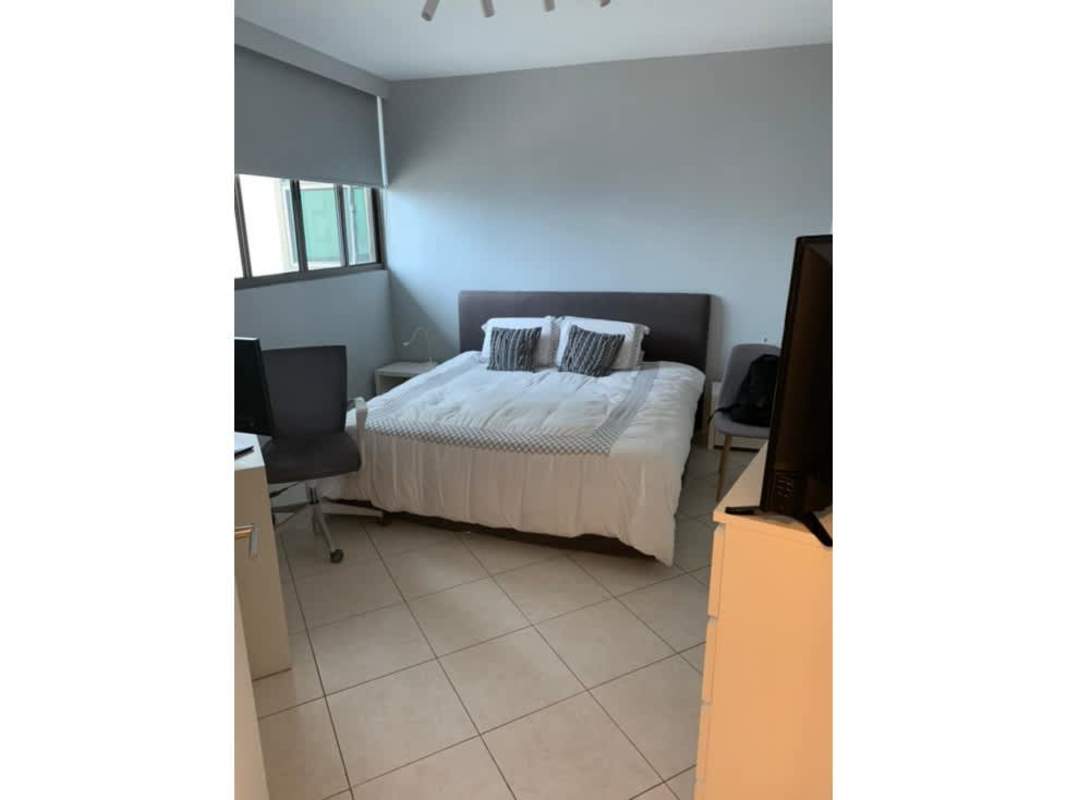 Open kitchen with island counter, chalkboard wall and stainless steel appliances PH Ocean Park Panama