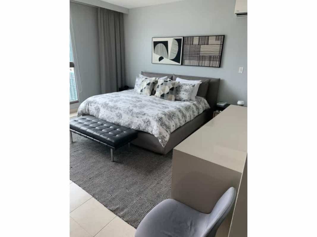 Modern bedroom with workspace, large window with city views PH Ocean Park Punta Pacifica Panama