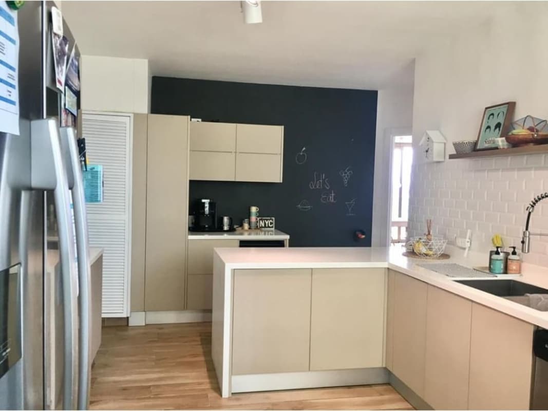 Kitchen with island, stainless steel appliances, white cabinetry in PH Ocean Park Punta Pacifica Panama