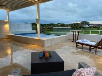 View of luxury villa's private plunge pool with sun deck overlooking gardens at Buenaventura Panama
