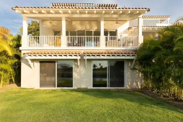 Bright open-plan living room with marble floors and garden views at Buenaventura villa rental