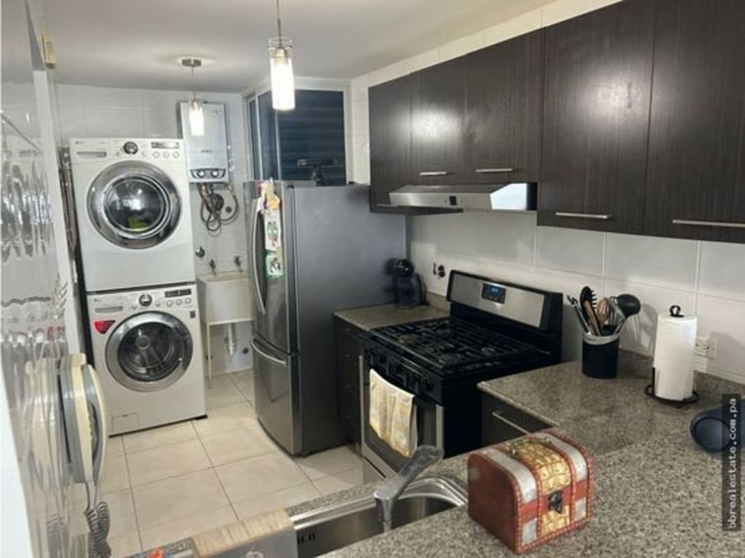 Kitchen with granite counters and laundry appliances in PH Belview Towers Panama