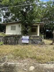 View of small rustic home with flat roof and trees in Panama countryside