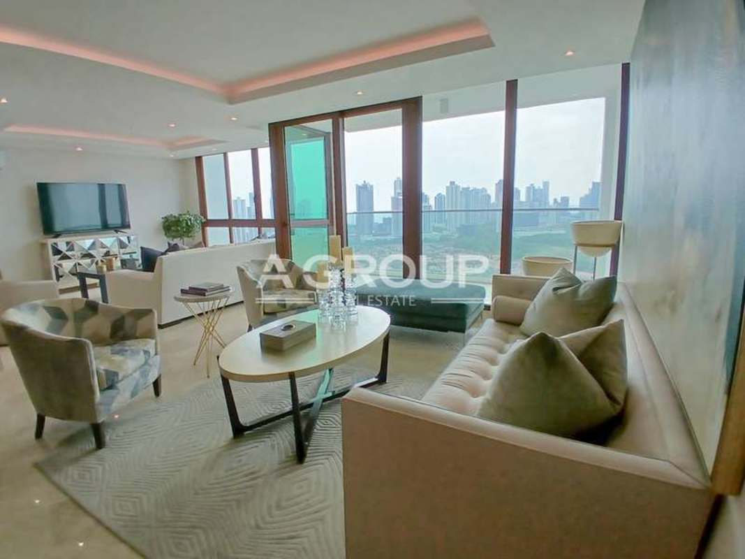 Elegant living room with large panoramic windows and city views in The Colonial Santa Maria Panama City