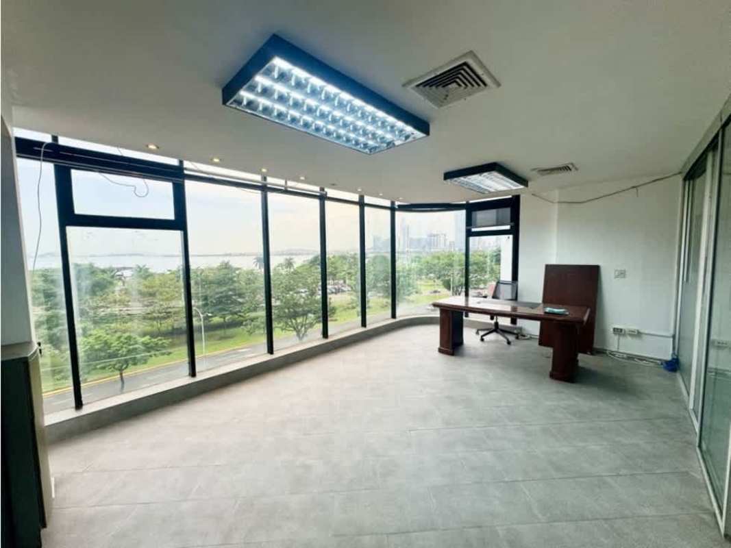 Modern office interior with floor-to-ceiling windows facing ocean at Avenida Balboa Bay Mall