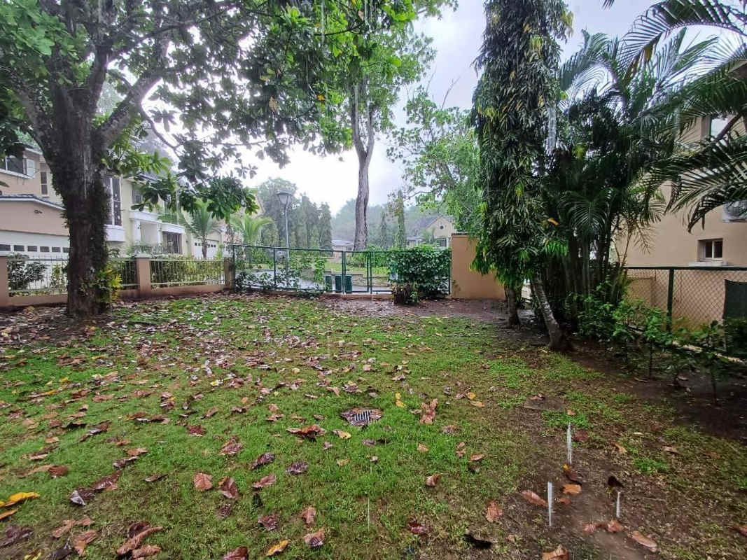 Two-story beige colonial style house large windows fenced yard Embassy Gardens Panama