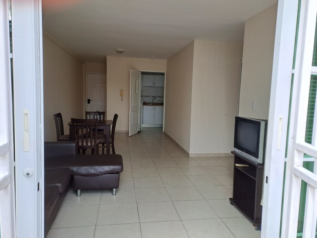 Open plan living and dining room with tiled floor at Parque Lefevre apartment for sale