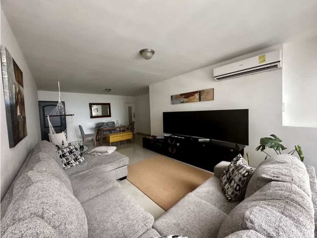 Laundry room with stacked washer dryer and wooden cabinetry PH San Francisco Bay Panama