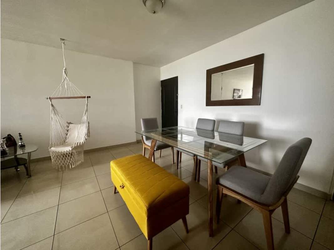 Bedroom featuring white walls, large window city view, flat screen TV PH San Francisco Bay Panama