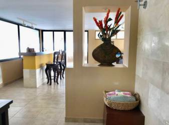 Bright living dining room with ocean views and balcony access at PH Bahia Resort Coronado