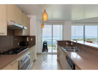 Second bedroom with large window overlooking greenery at Bijao Beach Club Panama