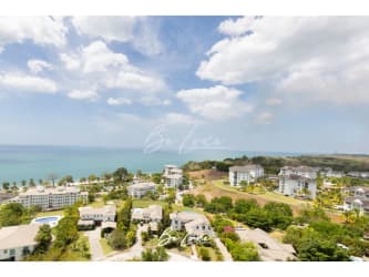 Aerial of Bijao Resort: oceanfront condos, beach, pools, landscape in Rio Hato Panama