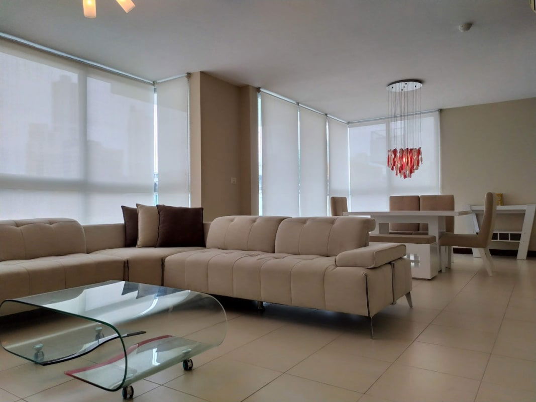Open concept living space with large windows and modern furniture in Costa del Este Tower Panama