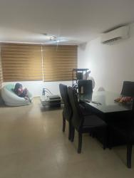 Living and dining area with large windows and access to terrace at Coronado beach house