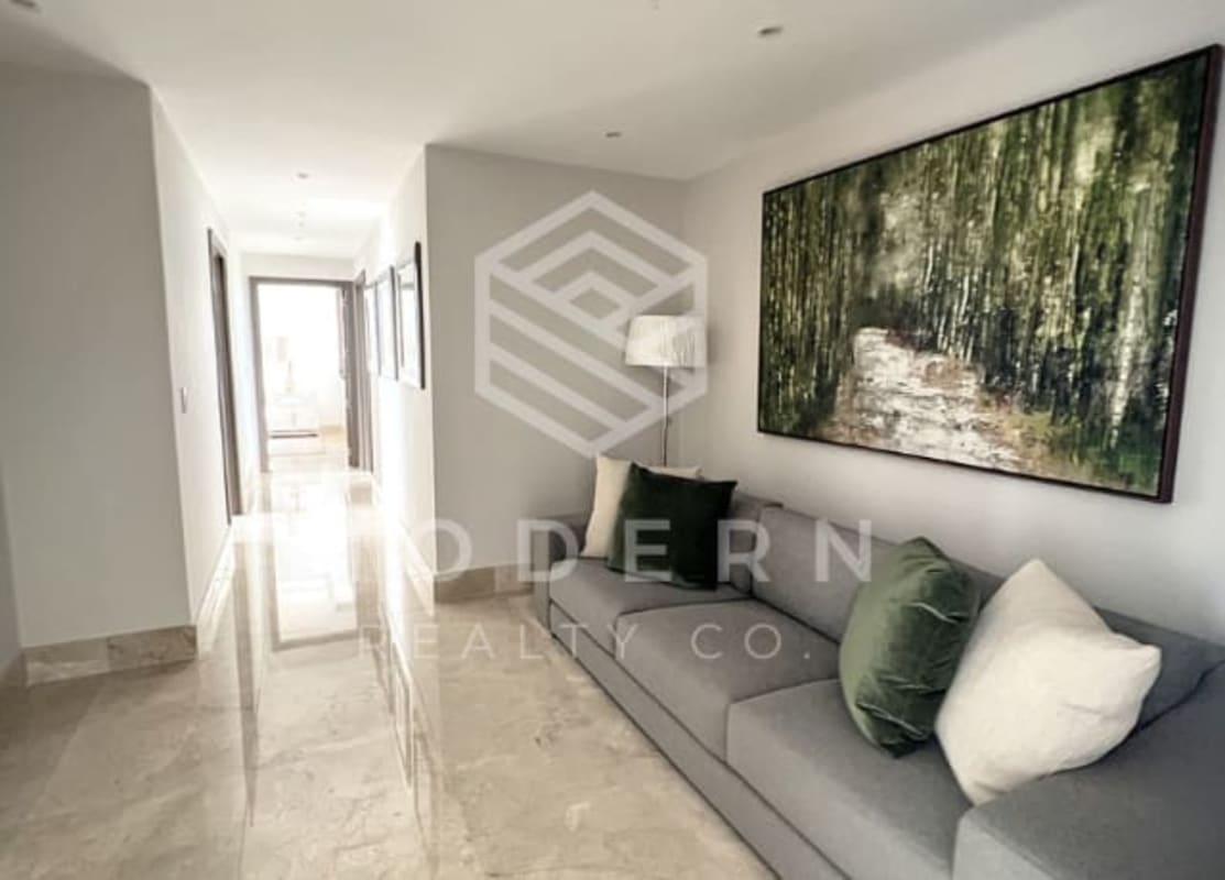 Spacious hallway with lounge seating marble floors in Santa Maria Golf condo Panama City