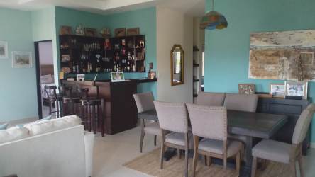 Expansive wrap-around terrace with outdoor dining overlooking lush gardens and pool in Hacienda Pacifica Panama