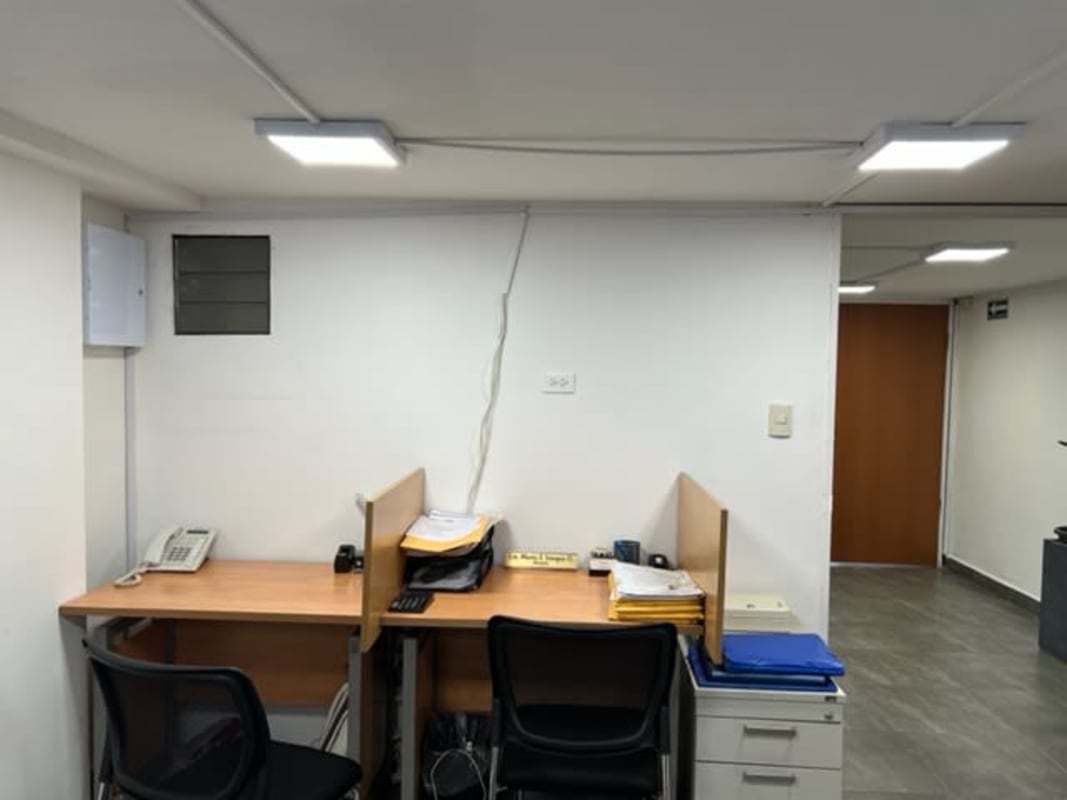 Reception area with white chairs, glass table in rental unit Panama