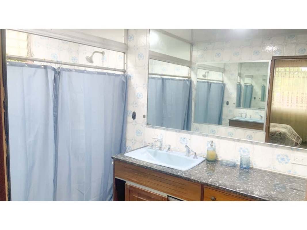 Large traditional bedroom with windows and floral bedding Panama City