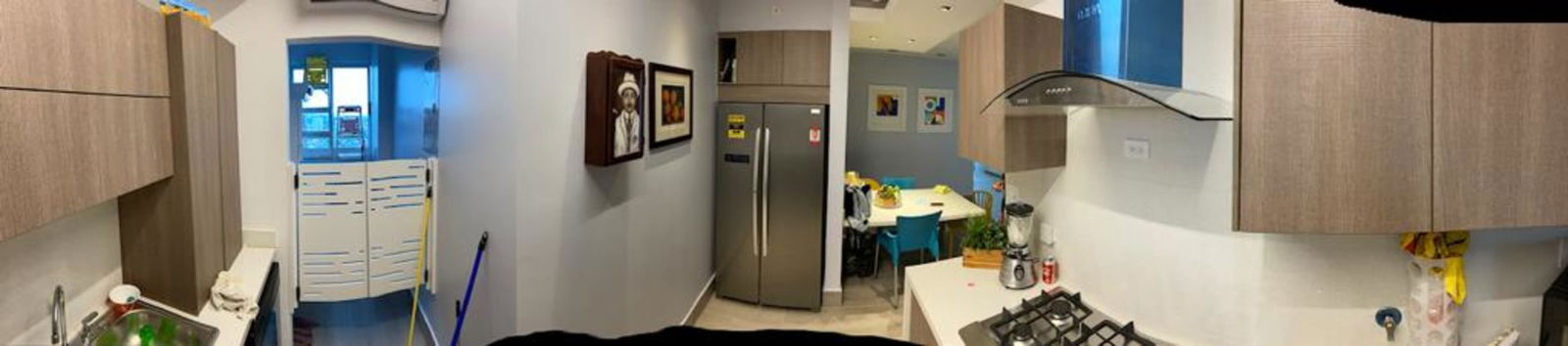 Modern kitchen with open dining area in penthouse apartment PH Carrasquilla Park View San Francisco