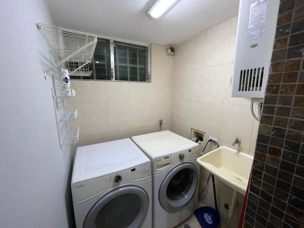 Modern bathroom with glass shower enclosure and neutral tiles at PH Sunflower Panama City